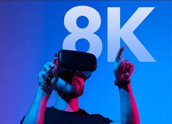 A person wearing a VR headset in front of the text 8K